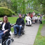 The team navigates the neighbourhood in their wheelchairs